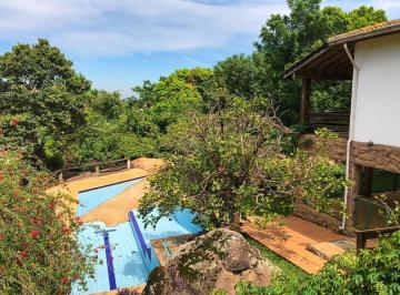 A natureza faz parte da construção. · Oportunidade de investimento em condomínio fechado no interior: piscina integrada à natureza, jardim