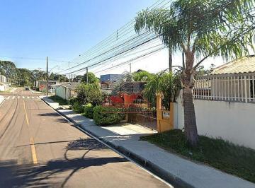 Fachada do terreno à venda na Rua Paraíba, Bairro Iguaçu, Araucária. Terreno limpo e pronto para construir, com pavimentação e iluminação pública. · Terreno ZR2 em Araucária - 12 Pavimentos no Bairro Iguaçu