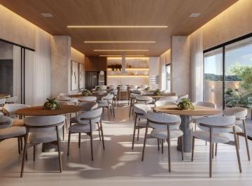 Salão de festas do pavimento de lazer, com cozinha de apoio e mesas redondas (imagem ilustrativa) · Apartamento de 78,66 m², 2 dormitórios e varanda lateral no Seventy