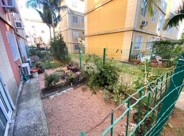 Apartamento · 61m² · 2 Quartos · 1 Vaga · Apartamento térreo com dois dormitórios, pátio privativo e vaga de garagem no Co
