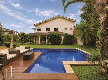 Piscina aquecida e fachada da casa de 4 suítes, no Jardim das Paineiras. · Casa em condomínio, Jardim das Paineiras, 4 suítes, piscina aquecida, gourmet, m